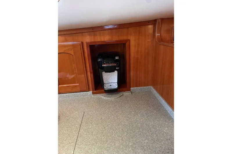 Off Islander Yacht Photos Pics 2007 Legacy Yachts 32 interior with built-in coffee maker and wooden cabinetry.