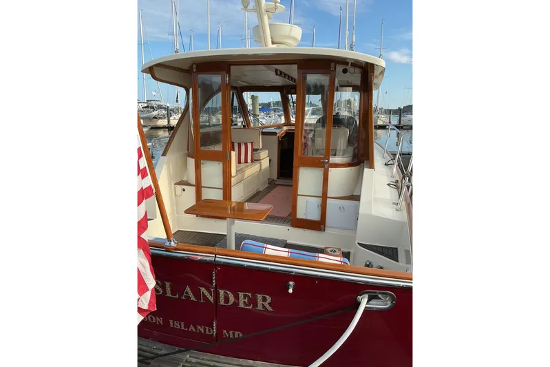 Off Islander Yacht Photos Pics 2007 Legacy Yachts 32 docked, featuring wooden doors and American flag.