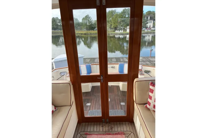 Off Islander Yacht Photos Pics Interior view of 2007 Legacy Yachts 32, featuring wooden doors and waterfront scenery.
