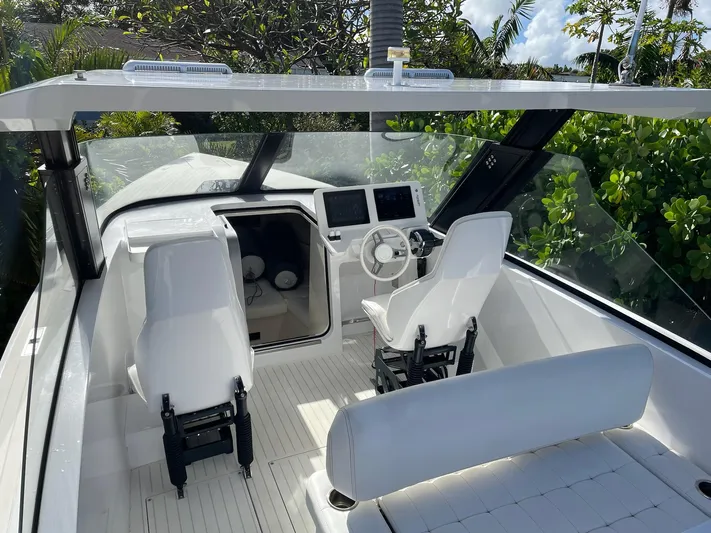 White Turtle Yacht Photos Pics 2019 Iguana Commuter boat interior with modern dashboard and seating.