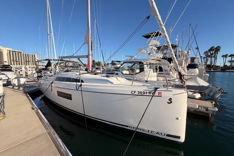  Yacht Photos Pics 2020 Beneteau Oceanis 30.1 sailboat docked at marina under clear blue sky.