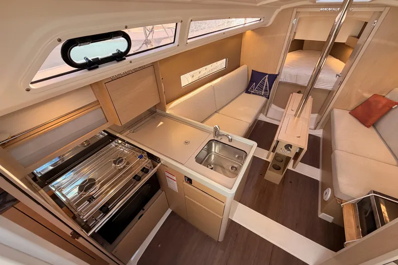  Yacht Photos Pics Interior of 2020 Beneteau Oceanis 30.1 yacht, featuring kitchen, seating, and sleeping area.