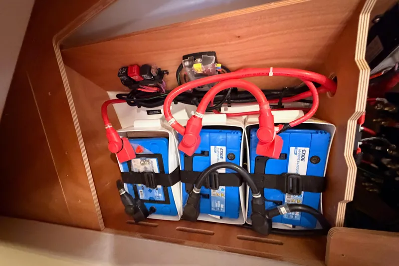  Yacht Photos Pics Battery compartment of 2020 Beneteau Oceanis 30.1 with red cables and Exide batteries.