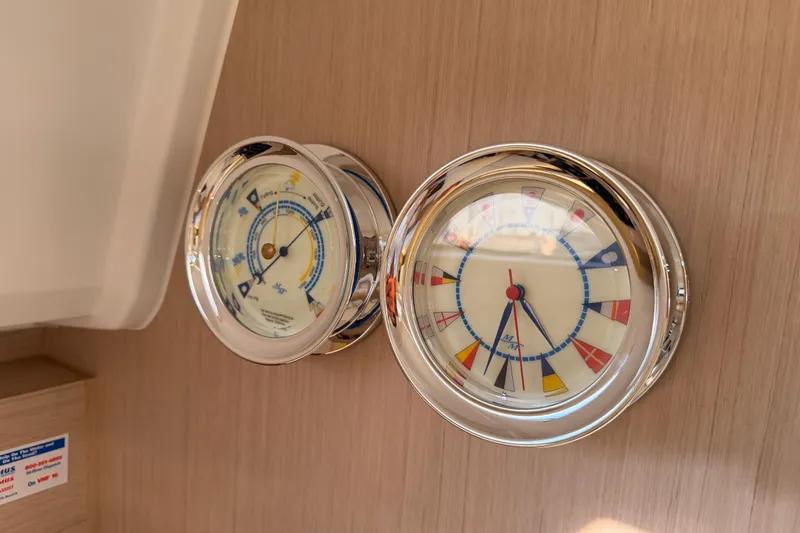  Yacht Photos Pics Nautical instruments on Beneteau Oceanis 30.1 yacht, 2020 model, featuring a clock and barometer.