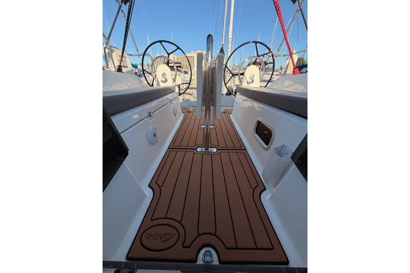  Yacht Photos Pics 2020 Beneteau Oceanis 30.1 yacht cockpit with dual steering wheels and teak flooring.