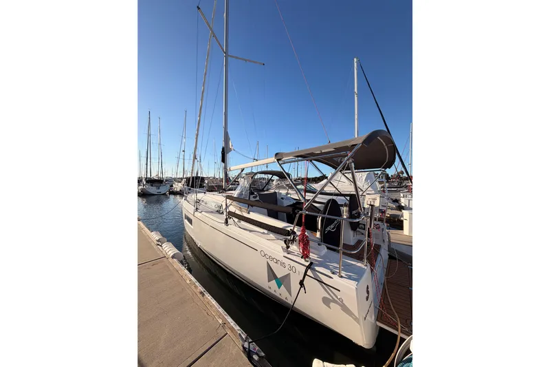  Yacht Photos Pics 2020 Beneteau Oceanis 30.1 sailboat docked at marina under clear blue sky.