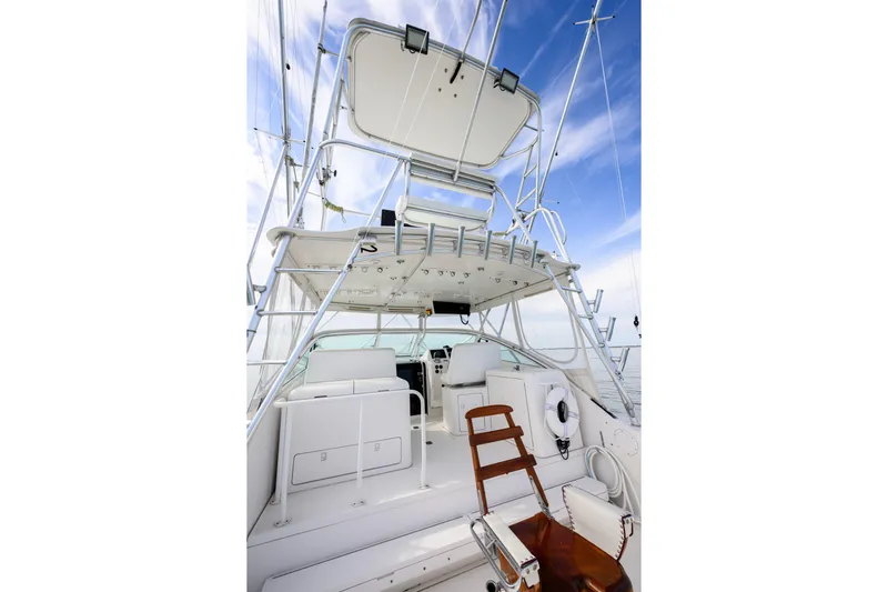Marlin Spike Yacht Photos Pics 1998 Bertram 36 Moppie yacht interior with seating, ladder, and clear sky background.