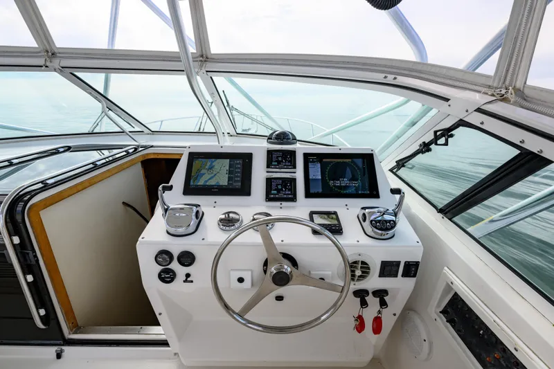 Marlin Spike Yacht Photos Pics Cockpit of 1998 Bertram 36 Moppie yacht with navigation equipment and steering wheel.