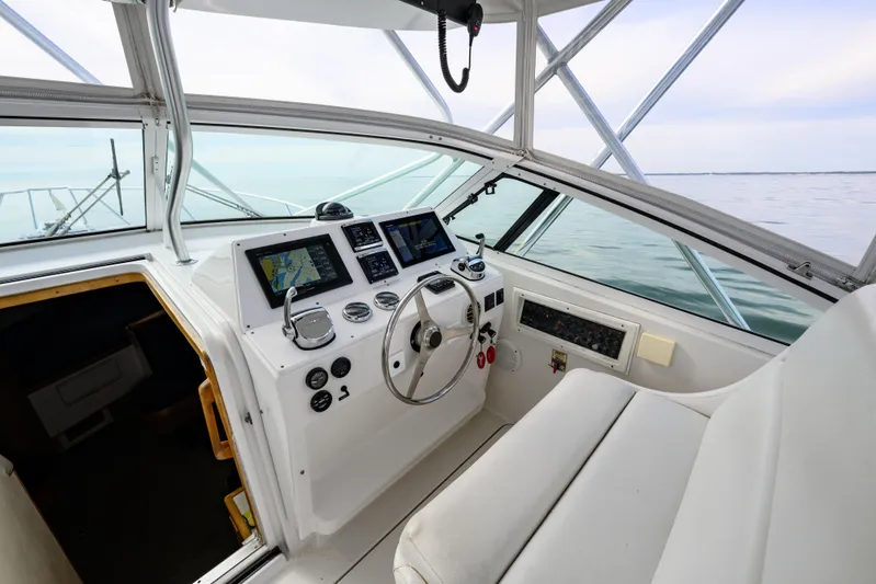 Marlin Spike Yacht Photos Pics Cockpit of a 1998 Bertram 36 Moppie boat with navigation equipment and steering wheel.