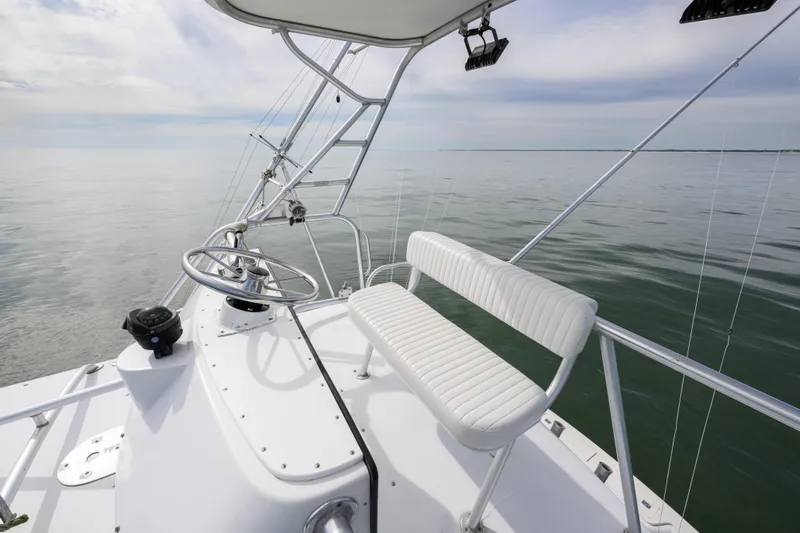 Marlin Spike Yacht Photos Pics 1998 Bertram 36 Moppie boat helm with white seating on calm water.