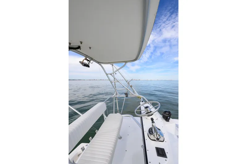 Marlin Spike Yacht Photos Pics 1998 Bertram 36 Moppie boat helm with ocean view and clear sky.