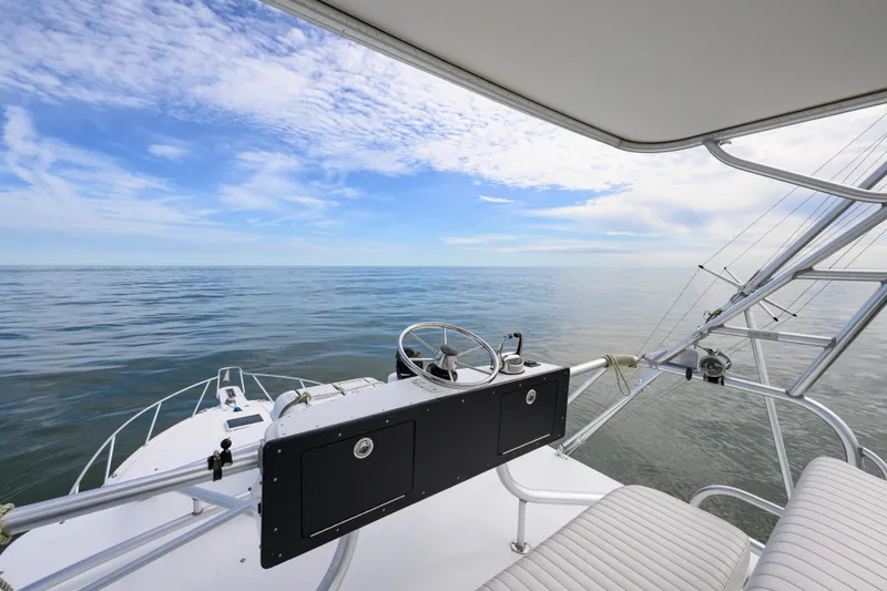 Marlin Spike Yacht Photos Pics 1998 Bertram 36 Moppie boat helm with ocean view under blue sky.