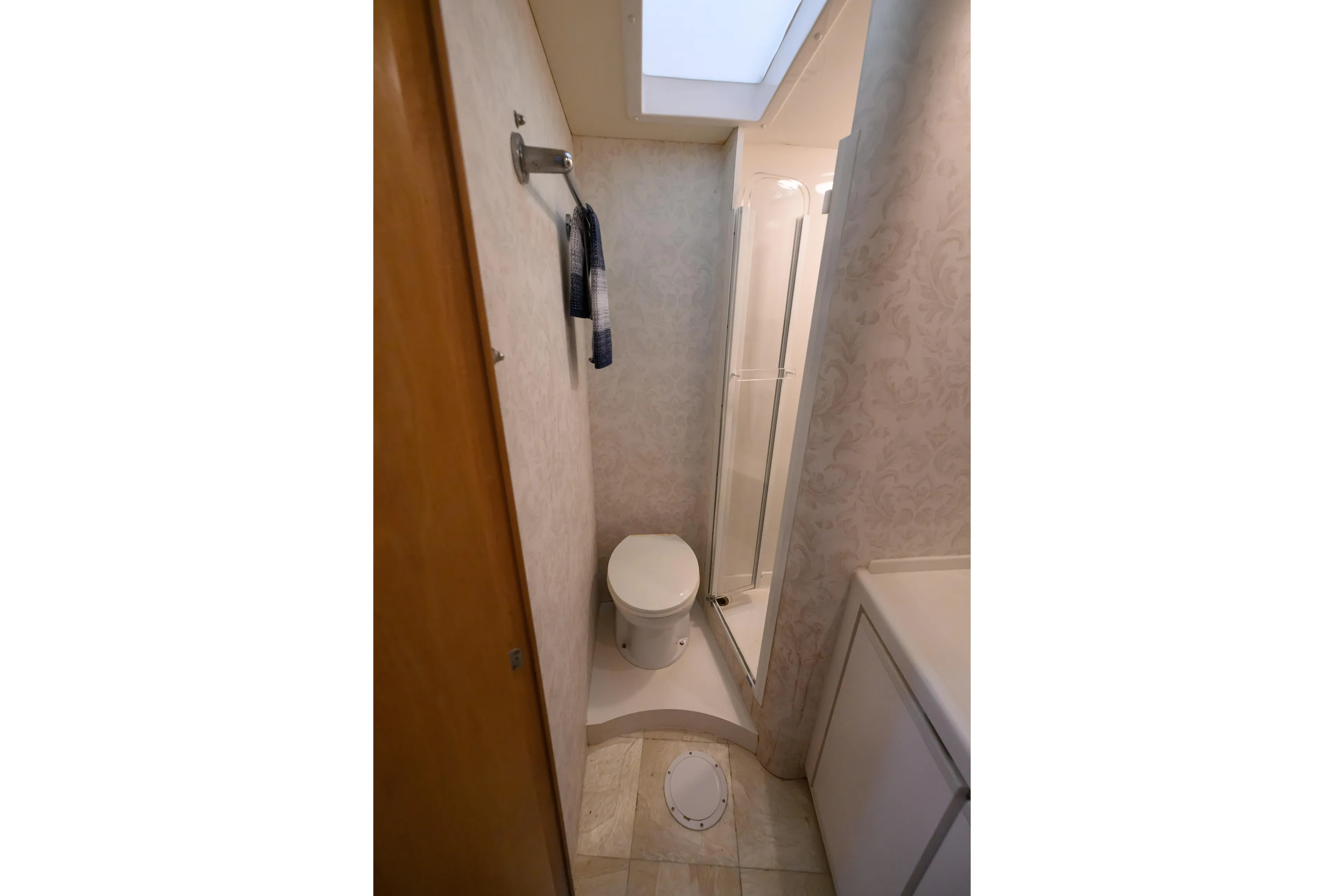 Marlin Spike Yacht Photos Pics Bathroom interior of 1998 Bertram 36 Moppie yacht, featuring toilet and shower.