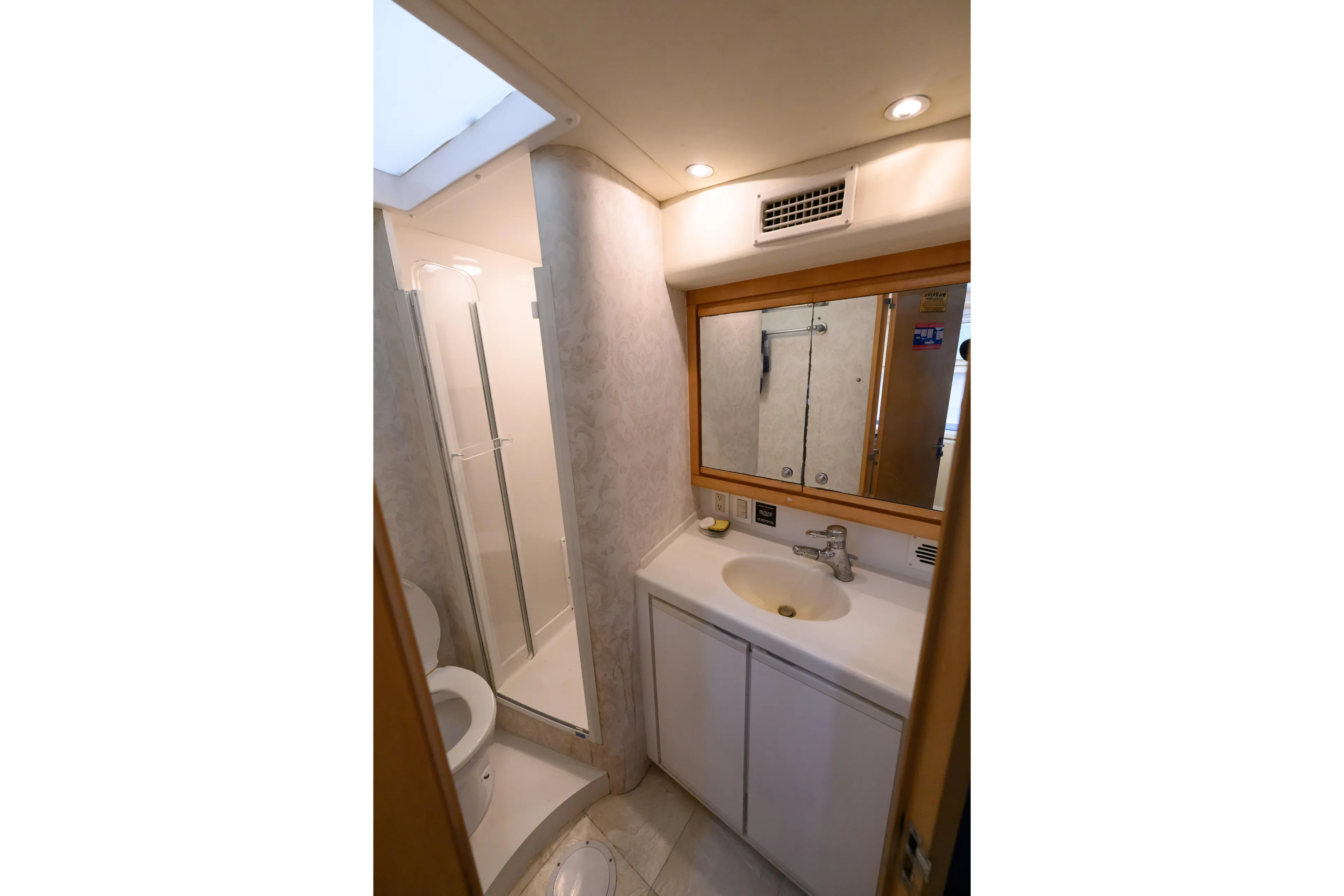 Marlin Spike Yacht Photos Pics Bathroom interior of 1998 Bertram 36 Moppie yacht with shower and vanity.