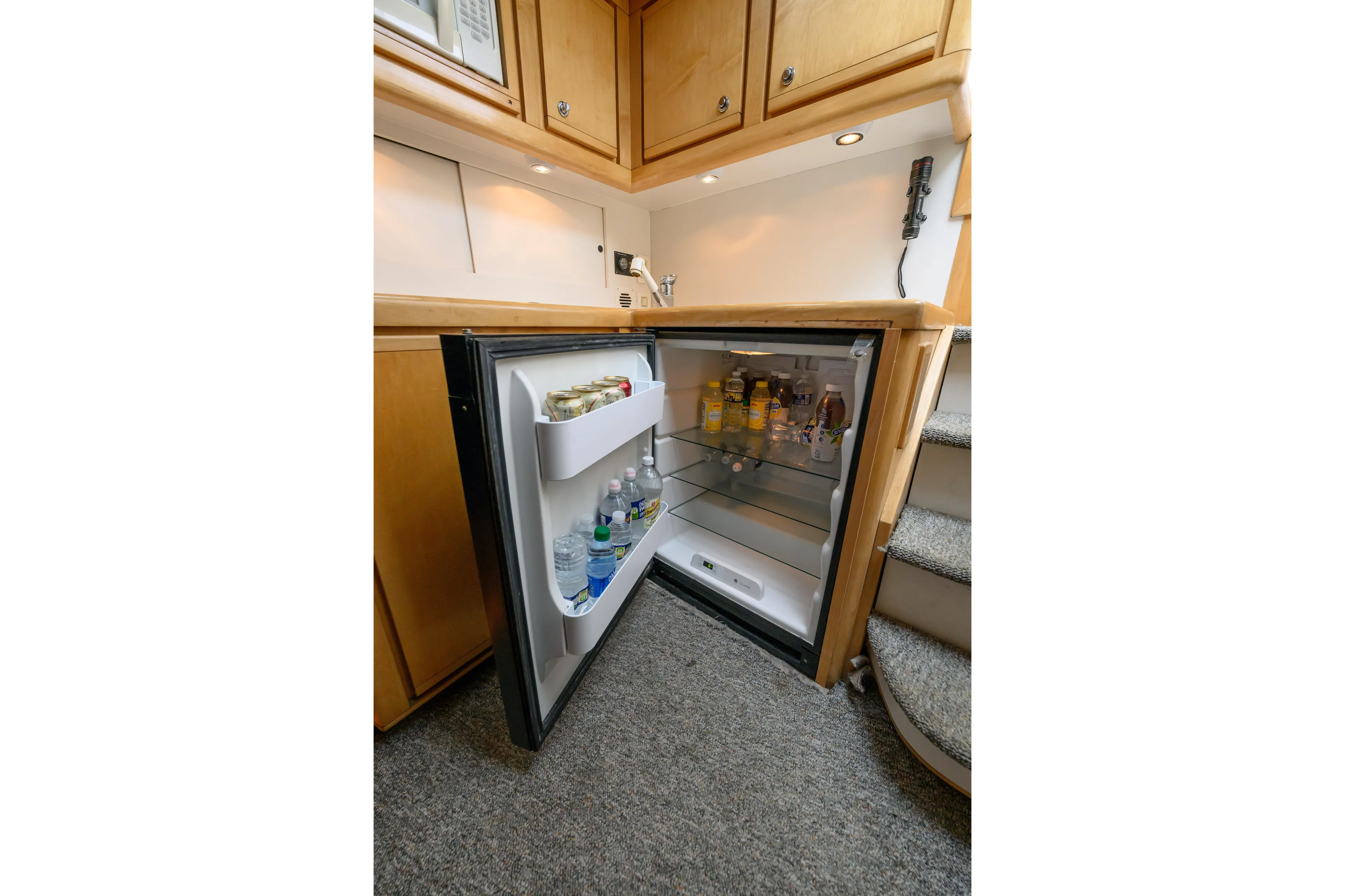 Marlin Spike Yacht Photos Pics Open fridge in 1998 Bertram 36 Moppie yacht interior, stocked with beverages.