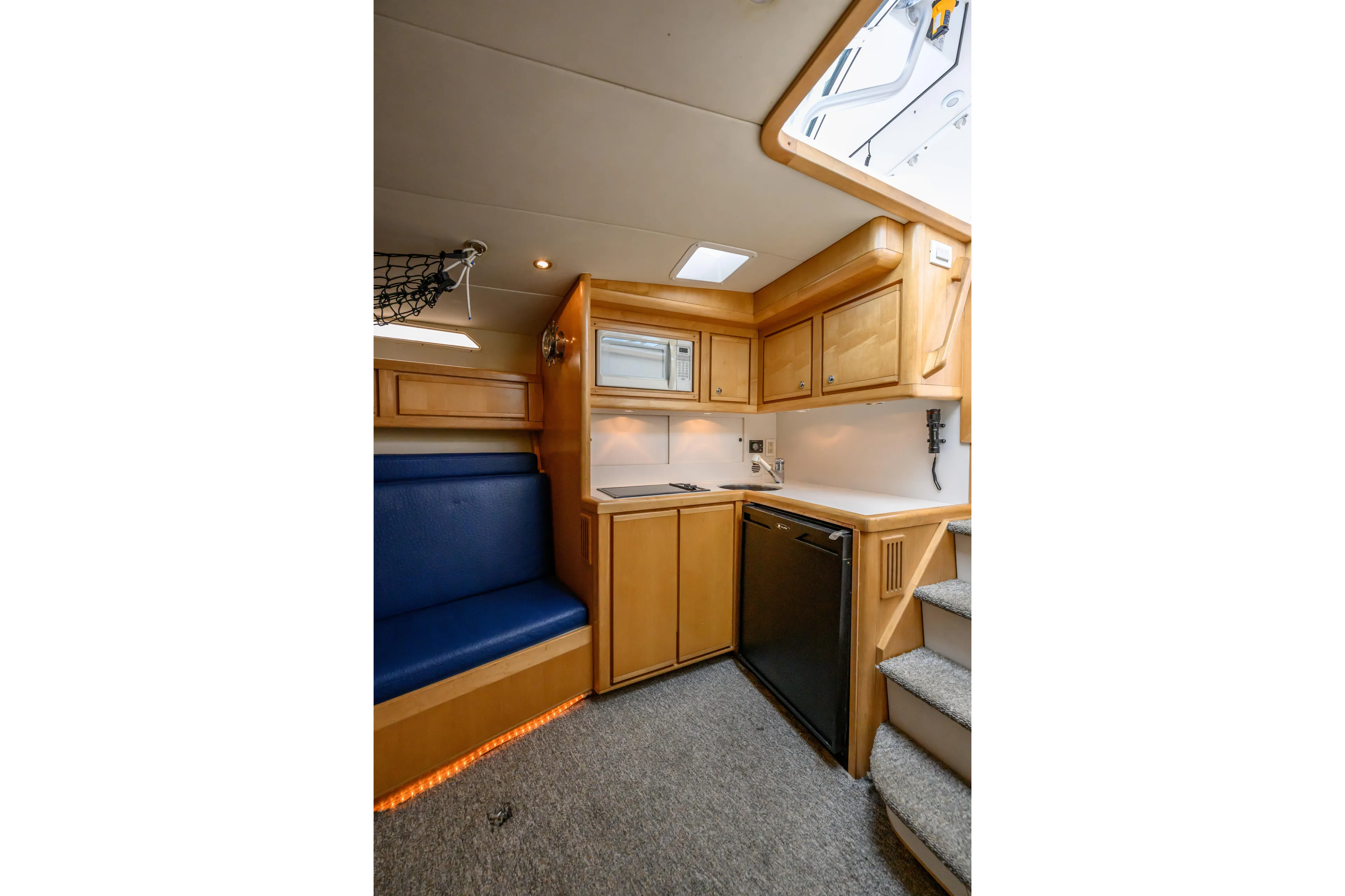 Marlin Spike Yacht Photos Pics Interior of 1998 Bertram 36 Moppie yacht with kitchenette and seating area.
