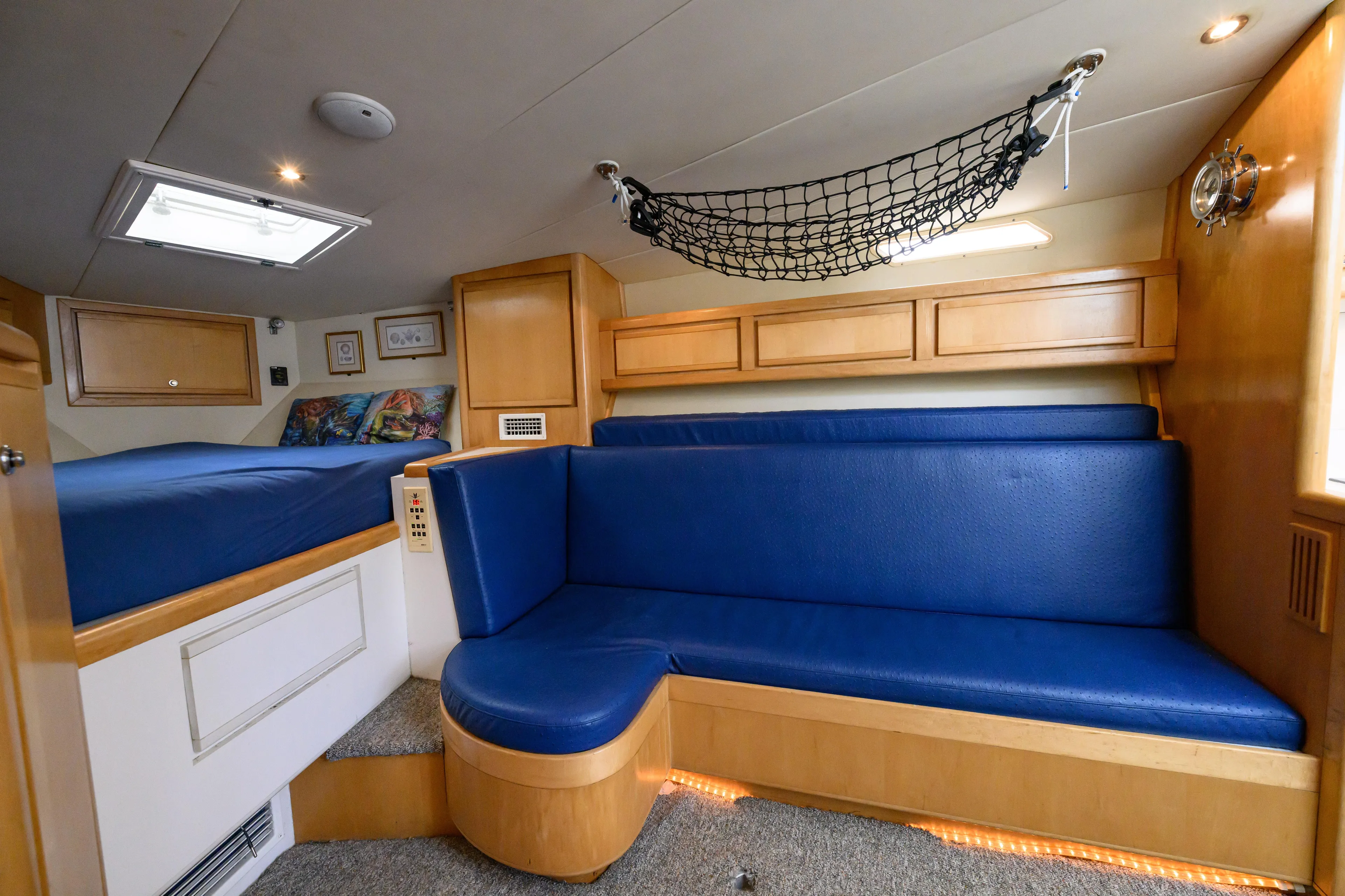 Marlin Spike Yacht Photos Pics Interior of 1998 Bertram 36 Moppie yacht with blue seating and wooden cabinetry.