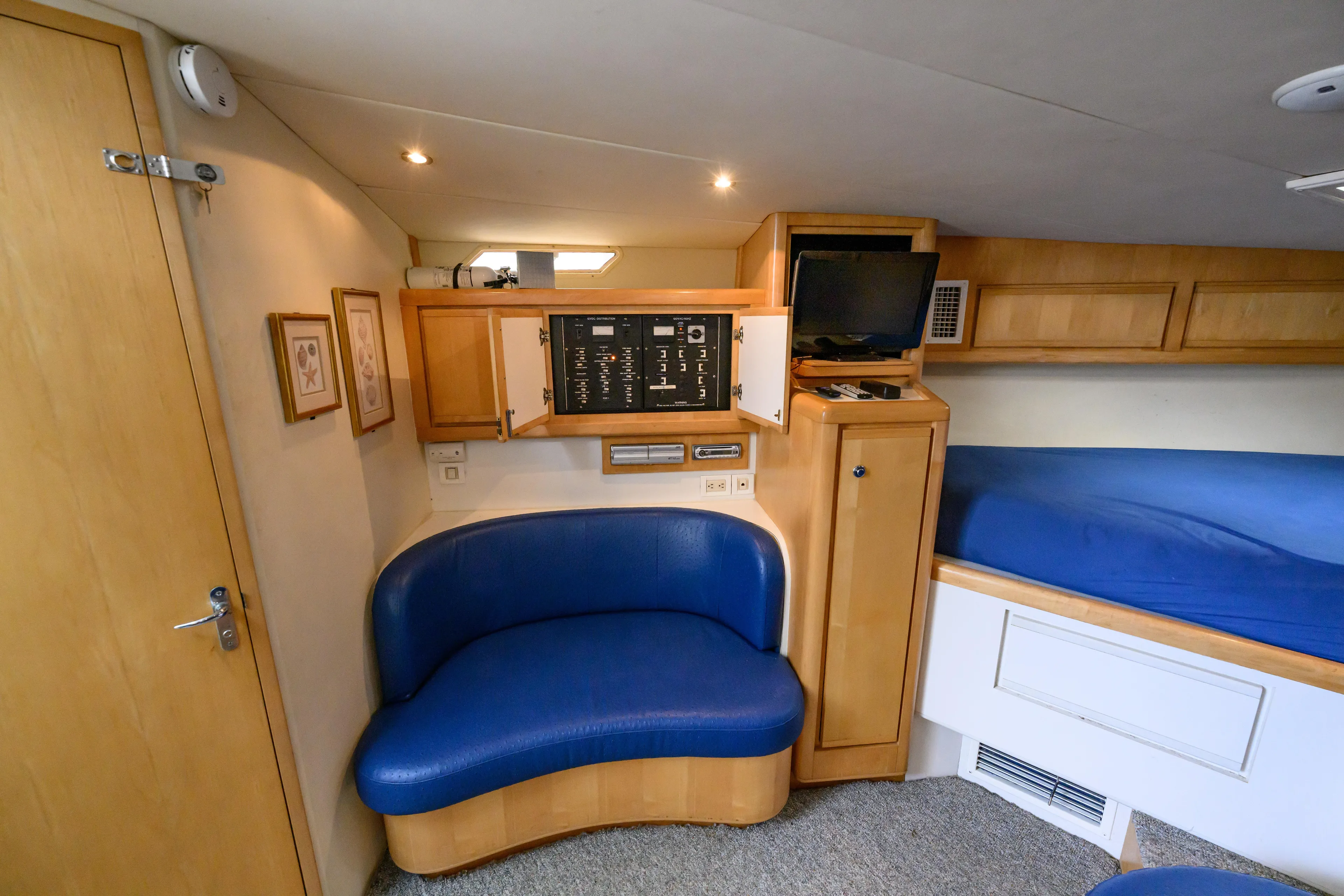 Marlin Spike Yacht Photos Pics Interior of 1998 Bertram 36 Moppie yacht with blue seating and control panel.
