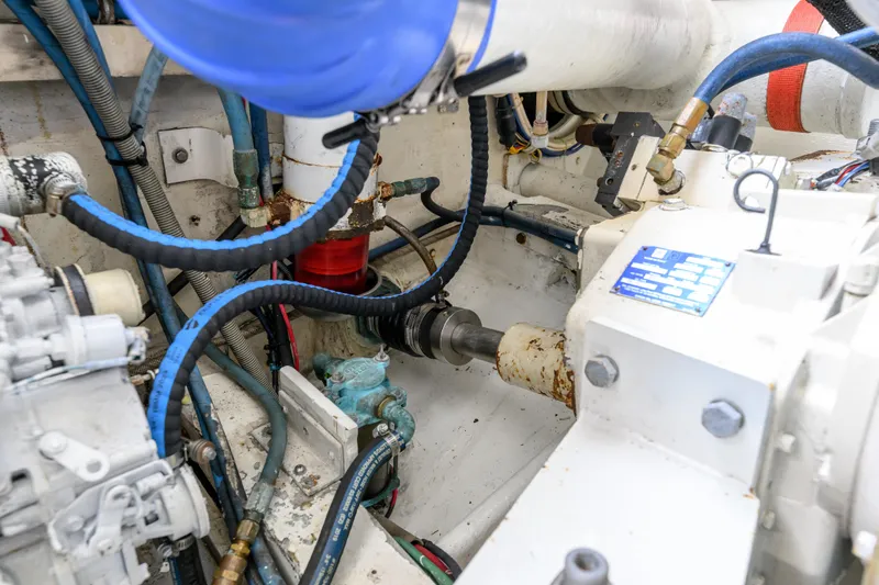 Marlin Spike Yacht Photos Pics Engine room of a 1998 Bertram 36 Moppie, featuring hoses and mechanical components.