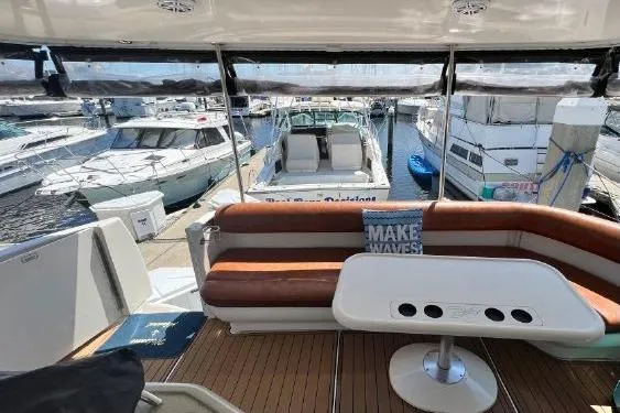 Infinity 2 Yacht Photos Pics 2004 Sea Ray 390 Motor Yacht interior with seating, table, and marina view.