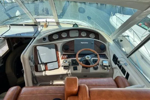 Infinity 2 Yacht Photos Pics 2004 Sea Ray 390 Motor Yacht helm with leather seating and navigation controls.