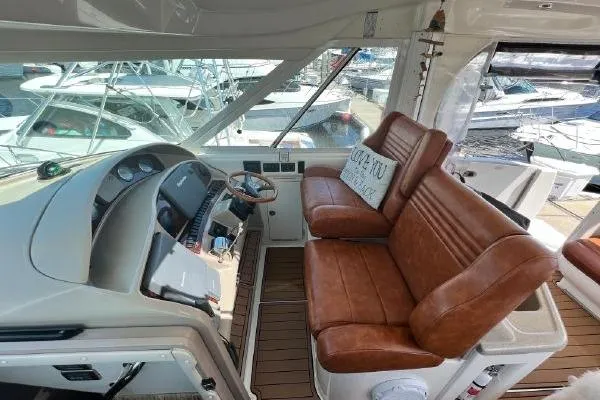 Infinity 2 Yacht Photos Pics 2004 Sea Ray 390 Motor Yacht helm with leather seating and marina view.