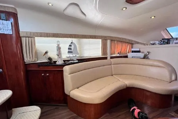 Infinity 2 Yacht Photos Pics Luxurious interior of 2004 Sea Ray 390 Motor Yacht with curved seating and elegant decor.