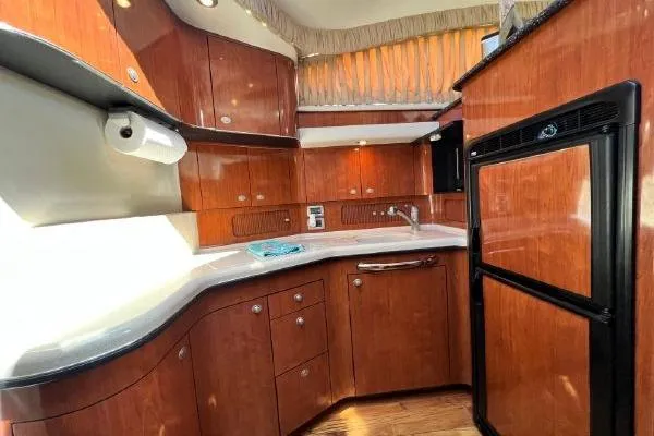 Infinity 2 Yacht Photos Pics 2004 Sea Ray 390 Motor Yacht kitchen with wood cabinetry and modern appliances.