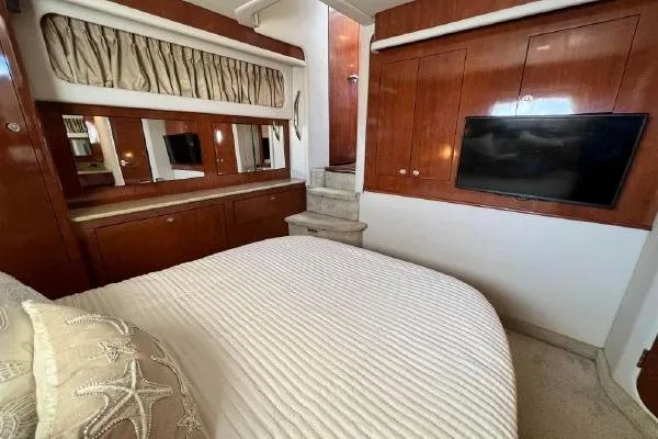 Infinity 2 Yacht Photos Pics Luxurious 2004 Sea Ray 390 Motor Yacht bedroom with elegant wood finishes and modern amenities.