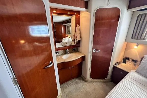 Infinity 2 Yacht Photos Pics Luxurious 2004 Sea Ray 390 Motor Yacht interior with wood finish and vanity area.