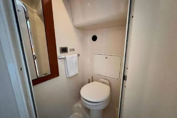 Infinity 2 Yacht Photos Pics Bathroom interior of 2004 Sea Ray 390 Motor Yacht, featuring toilet and mirror.