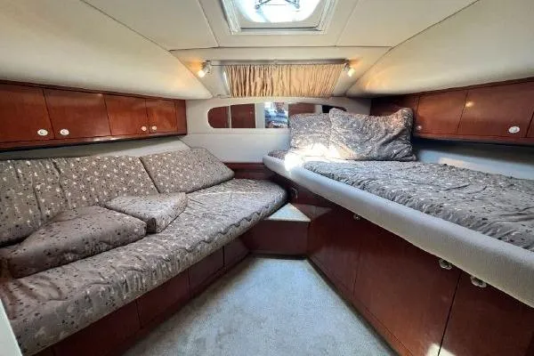 Infinity 2 Yacht Photos Pics Luxurious 2004 Sea Ray 390 Motor Yacht cabin with cozy bedding and elegant wood finishes.