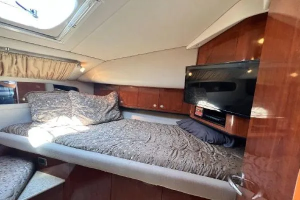 Infinity 2 Yacht Photos Pics Luxurious cabin interior of 2004 Sea Ray 390 Motor Yacht with cozy bed and TV.