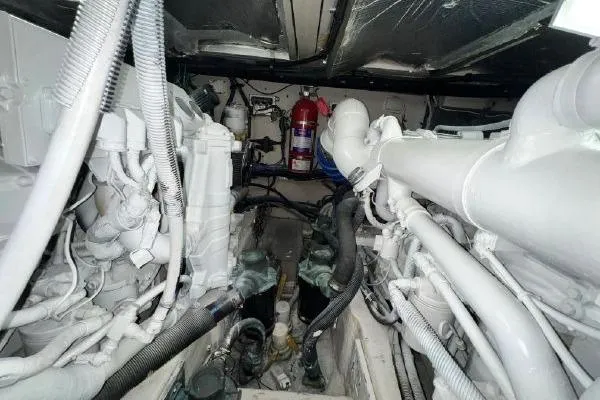 Infinity 2 Yacht Photos Pics Engine room of a 2004 Sea Ray 390 Motor Yacht, showcasing mechanical components and fire extinguisher.