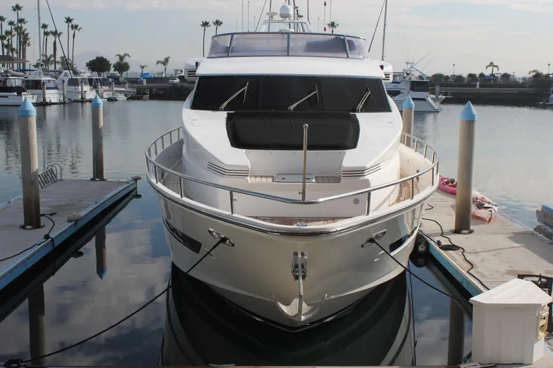 Allegro Yacht Photos Pics 1999 Horizon 70 Motor Yacht docked at marina, front view with calm water and clear sky.