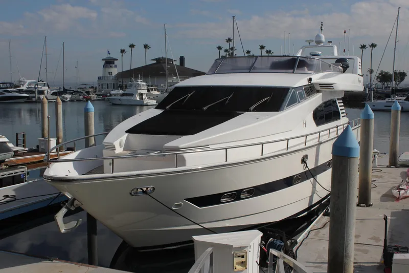 Allegro Yacht Photos Pics 1999 Horizon 70 Motor Yacht docked at a marina under a partly cloudy sky.