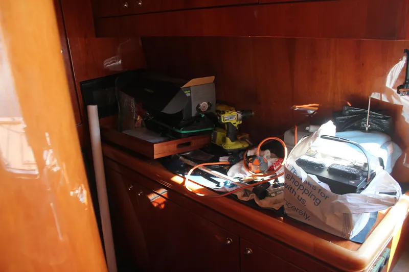 Allegro Yacht Photos Pics Interior of 1999 Horizon 70 Motor Yacht with tools and equipment on wooden surface.