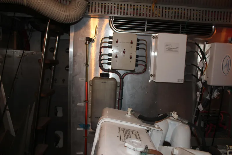 Allegro Yacht Photos Pics Engine room of a 1999 Horizon 70 Motor Yacht with control panels and equipment.