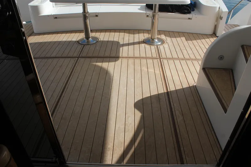 Allegro Yacht Photos Pics Teak deck of 1999 Horizon 70 Motor Yacht with seating and table.