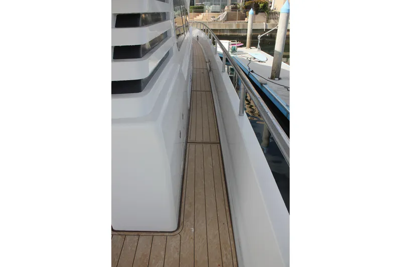 Allegro Yacht Photos Pics Side deck of a 1999 Horizon 70 Motor Yacht with wooden flooring and railing.