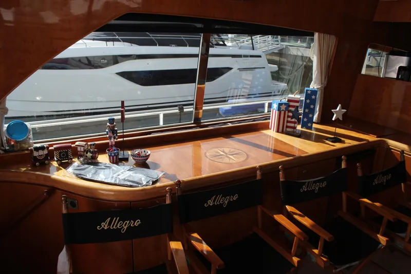 Allegro Yacht Photos Pics Interior of 1999 Horizon 70 Motor Yacht with decorative items and "Allegro" chairs.