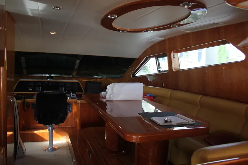 Allegro Yacht Photos Pics Luxurious interior of a 1999 Horizon 70 Motor Yacht with wood finishes and seating area.