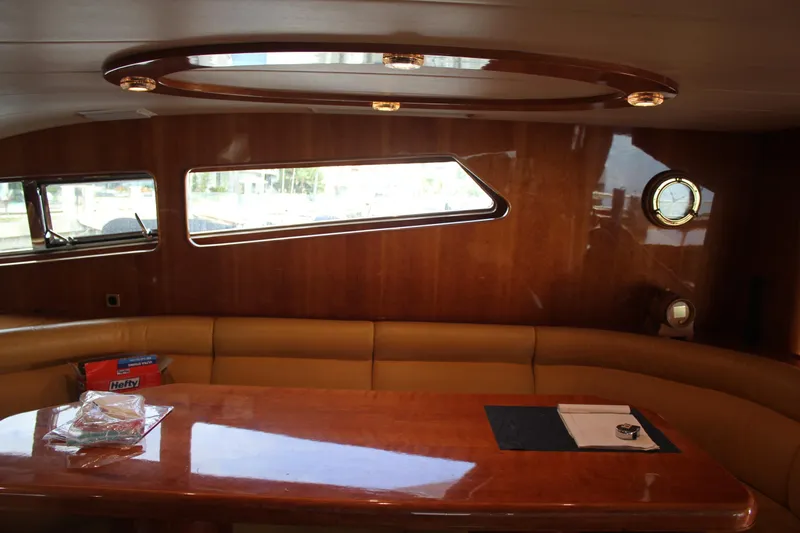 Allegro Yacht Photos Pics Luxurious interior of 1999 Horizon 70 Motor Yacht with wooden table and leather seating.
