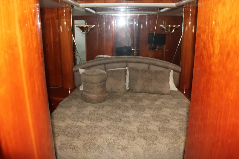 Allegro Yacht Photos Pics Luxurious bedroom interior of 1999 Horizon 70 Motor Yacht with plush bedding.