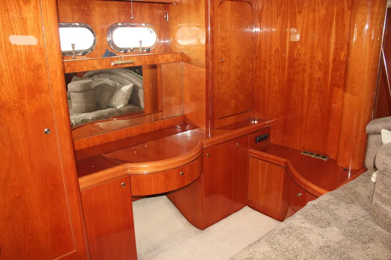 Allegro Yacht Photos Pics Luxurious wood interior of 1999 Horizon 70 Motor Yacht with elegant cabinetry and porthole windows.