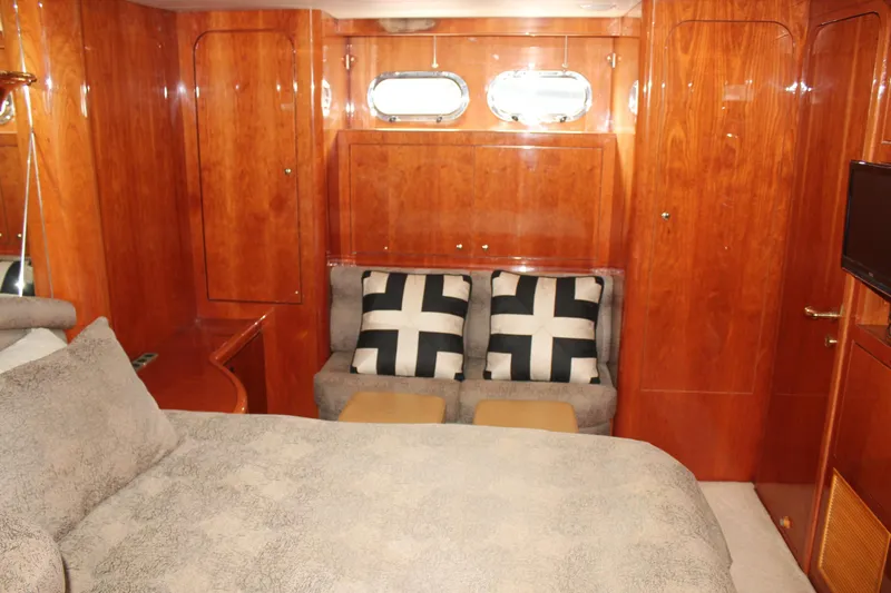 Allegro Yacht Photos Pics Luxurious 1999 Horizon 70 Motor Yacht cabin with wood paneling and cozy seating.