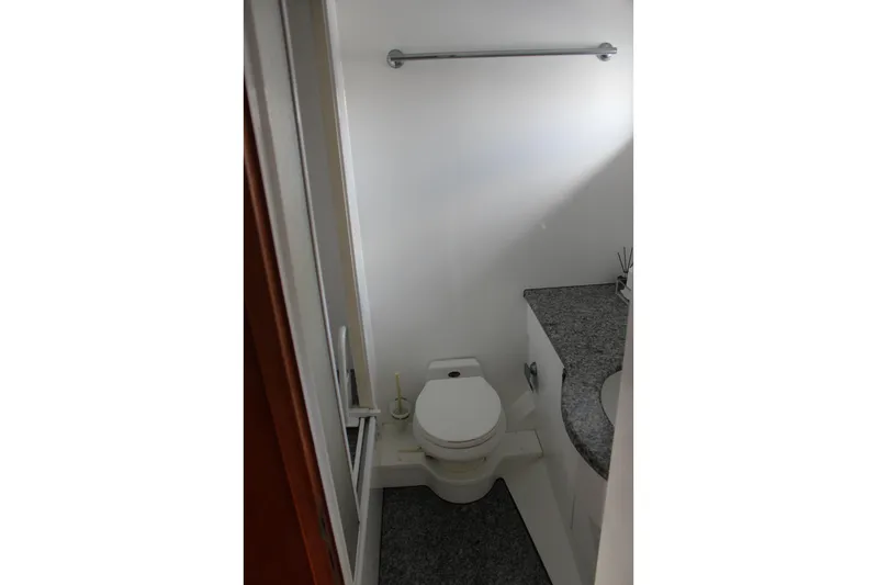 Allegro Yacht Photos Pics Bathroom interior of 1999 Horizon 70 Motor Yacht with toilet and granite countertop.