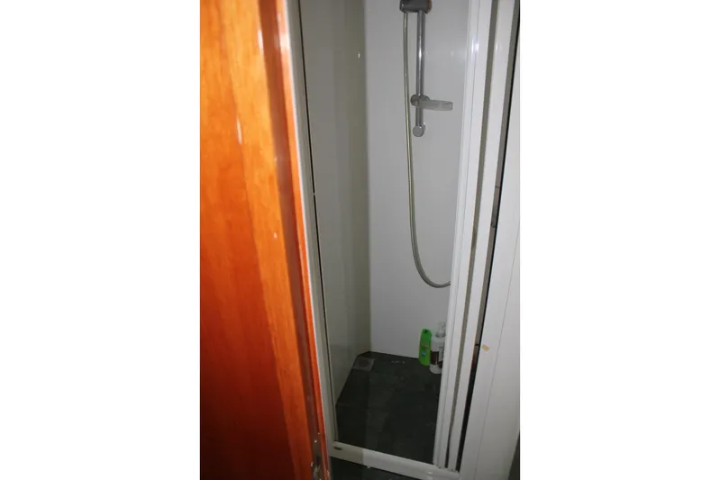 Allegro Yacht Photos Pics Shower area in 1999 Horizon 70 Motor Yacht with wooden door and modern fixtures.