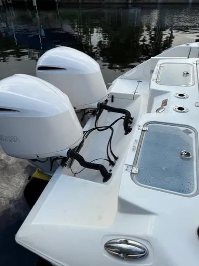  Yacht Photos Pics 2018 Cobia 320 CC boat with dual outboard engines docked by the water.