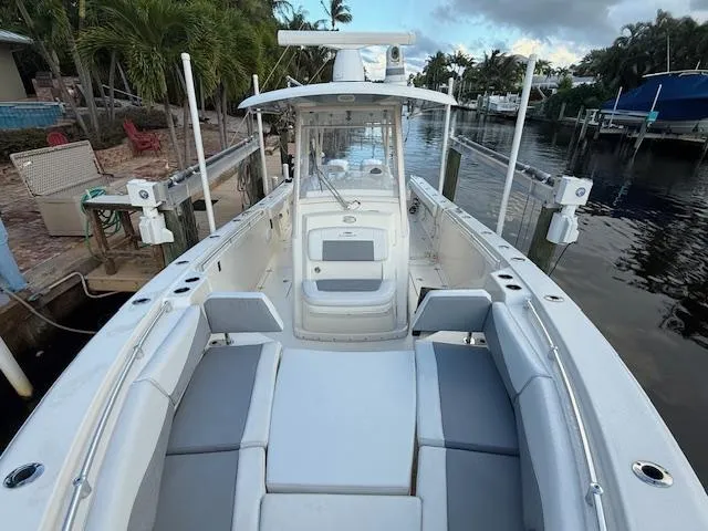  Yacht Photos Pics 2018 Cobia 320 CC boat docked, featuring spacious seating and sleek design.